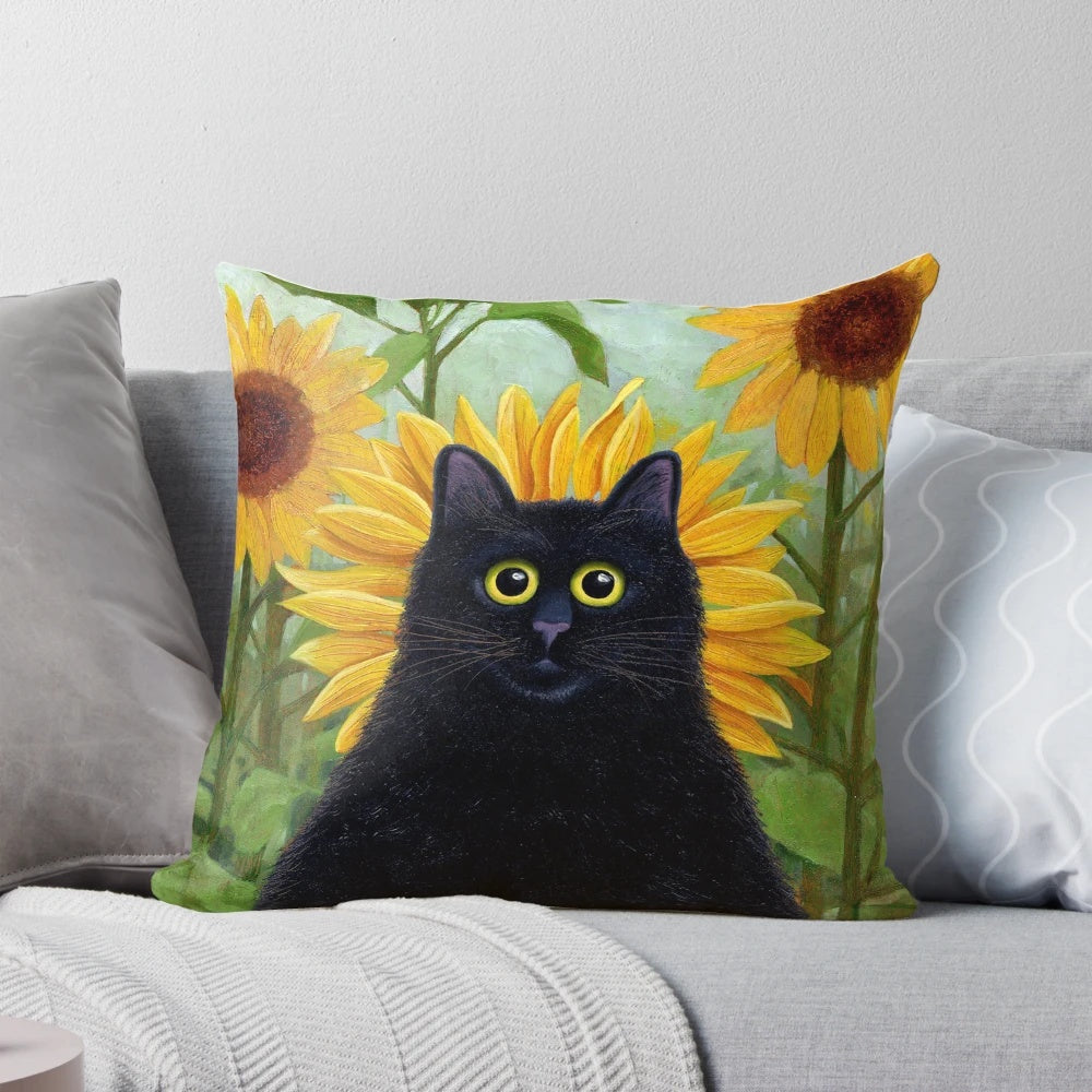 A decorative black cat pillow featuring a playful design with dandelions and sunflowers