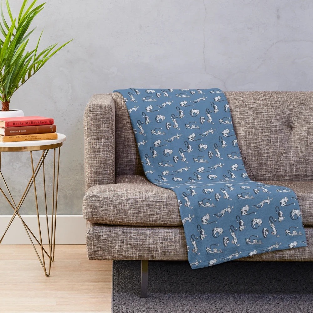 Playful cats in black and white cartoon design on a soft plush blanket