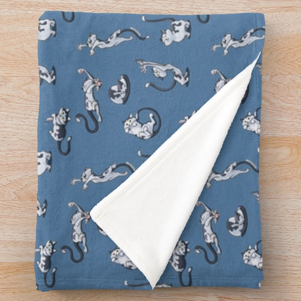 Playful cats in black and white cartoon design on a soft plush blanket