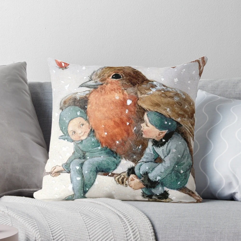 A decorative pillow featuring a charming illustration of Christmas elves sheltering with a robin in a snowy woodland setting.