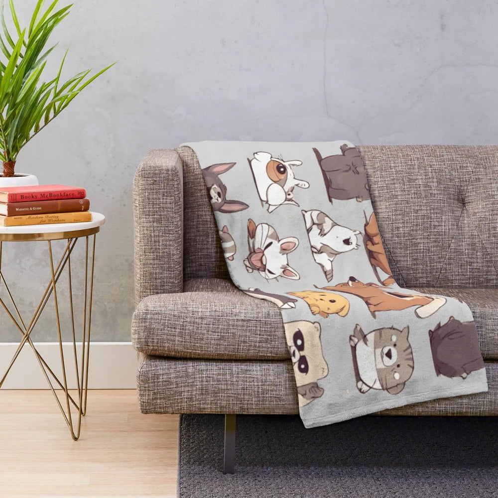 Colorful animal plush blanket with cute, whimsical forest creature designs