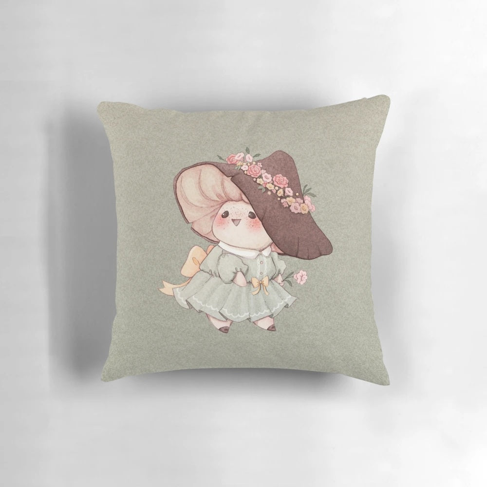 A soft, plush pillow featuring a cute mushroom design surrounded by delicate flowers in pastel colors, perfect for a cozy, fairytale-inspired home.