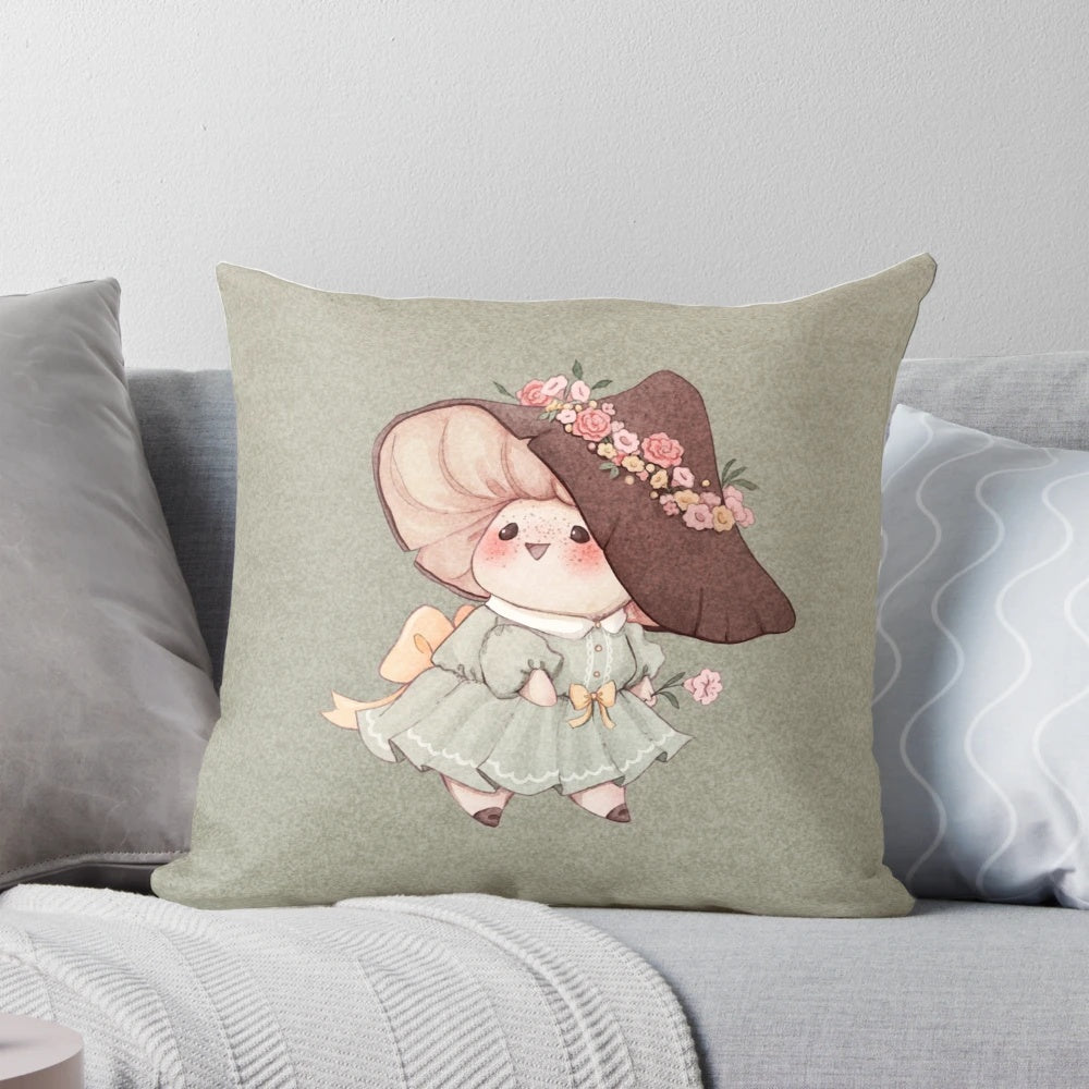 A soft, plush pillow featuring a cute mushroom design surrounded by delicate flowers in pastel colors, perfect for a cozy, fairytale-inspired home.