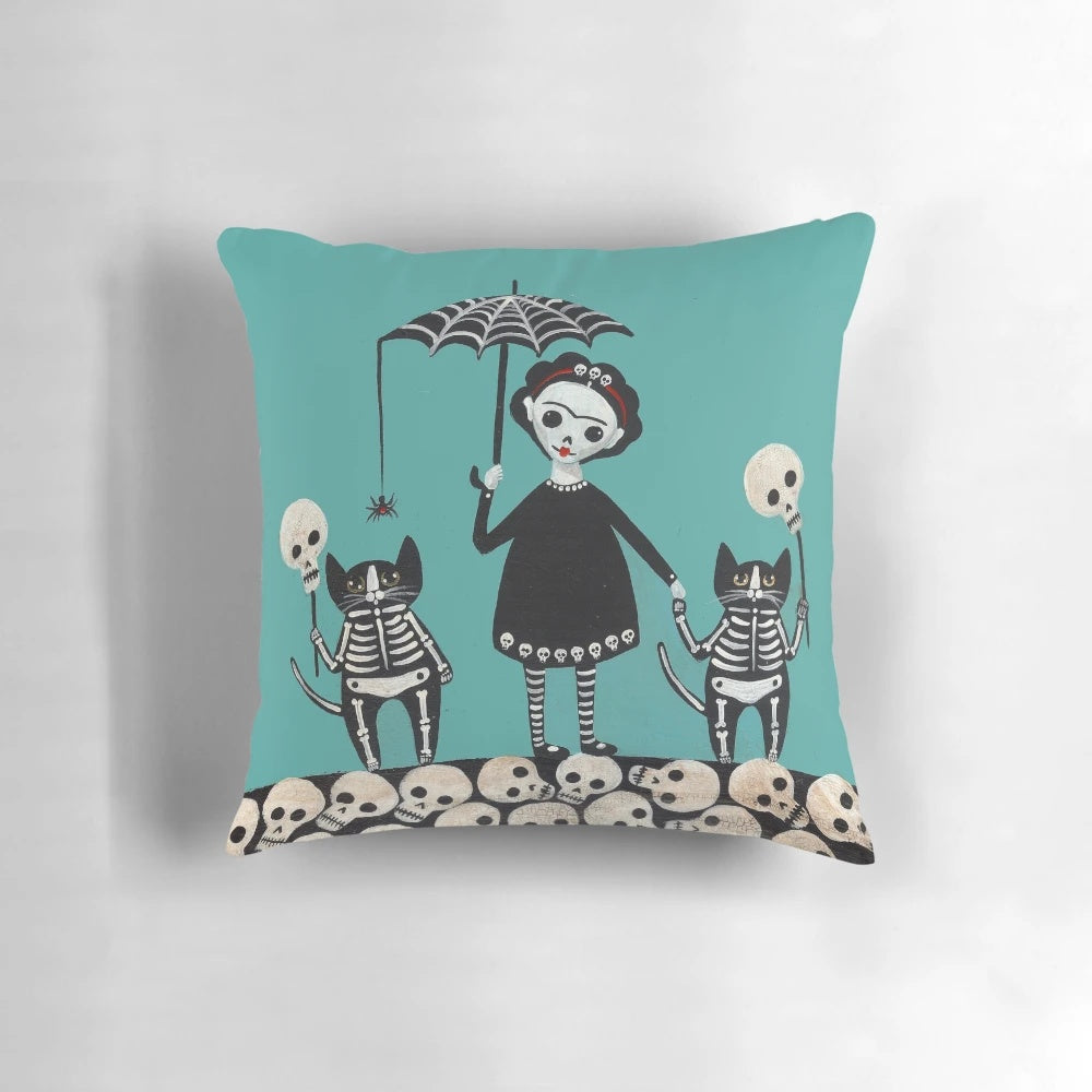 Colorful Day of the Dead pillow featuring playful skeletal cats in a whimsical folk art design.
