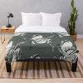 A plush blanket featuring a whimsical fairytale frog playing a banjo in a woodland setting