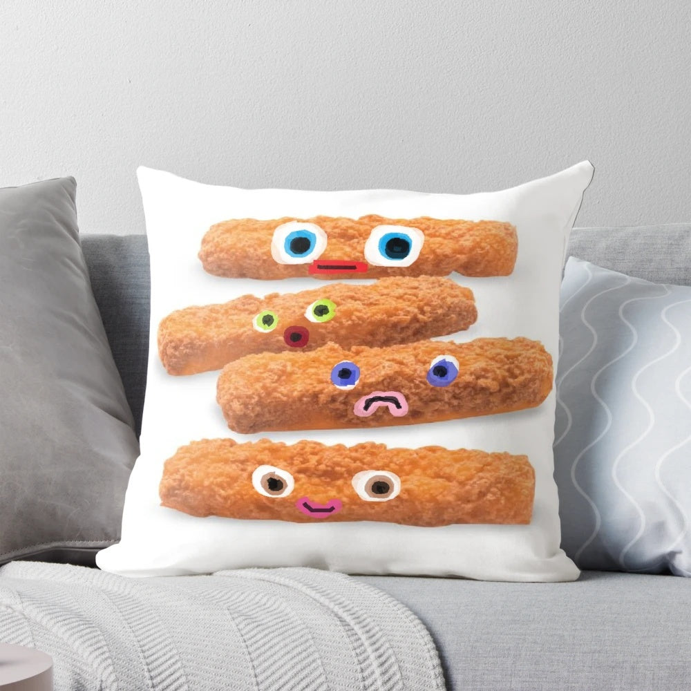 A plush pillow featuring a design of colorful "fish sticks with faces" in shades of orange, blue, green, and pink.