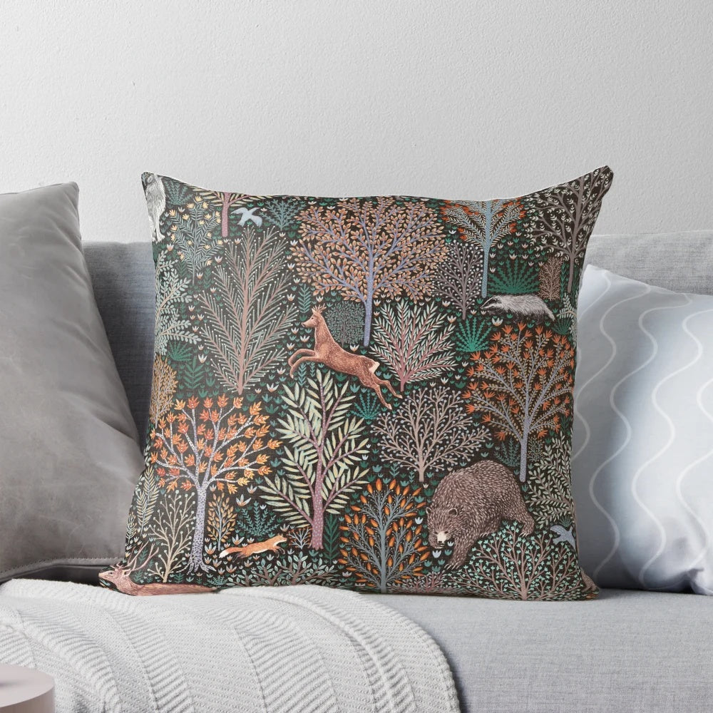 Decorative pillow featuring an illustration of forest animals like bears, deer, and wild boar amongst autumn leaves and trees.