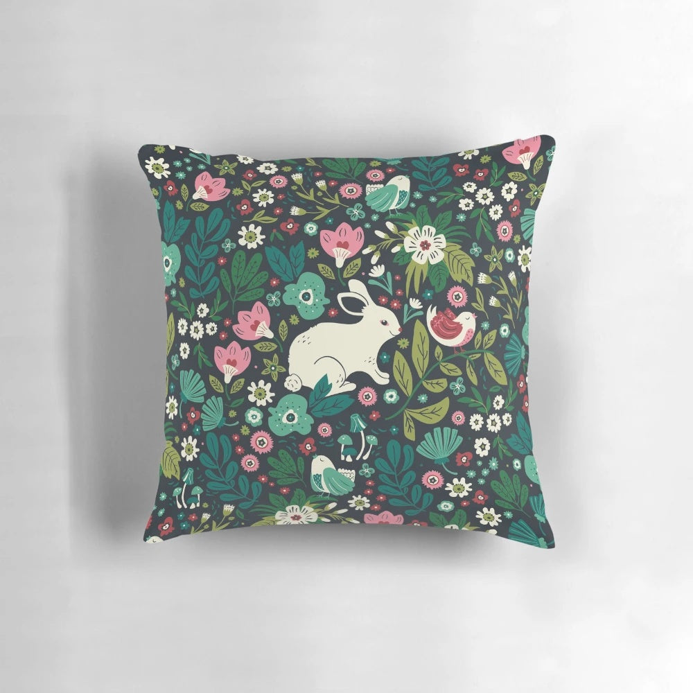 A cozy pillow featuring a whimsical pattern of forest animals and florals, perfect for kids' rooms and Mothers Day.