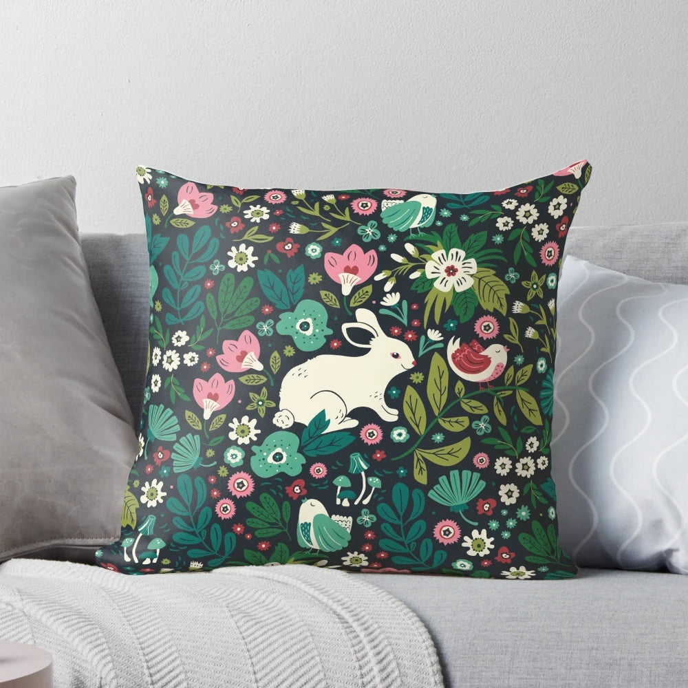 A cozy pillow featuring a whimsical pattern of forest animals and florals, perfect for kids' rooms and Mothers Day.
