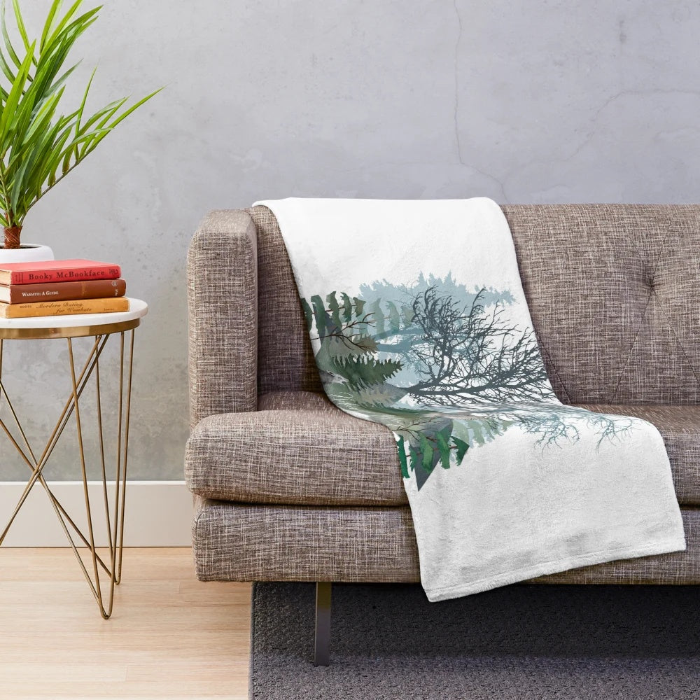 Plush blanket featuring a whimsical illustration of a forest, flora, and fauna