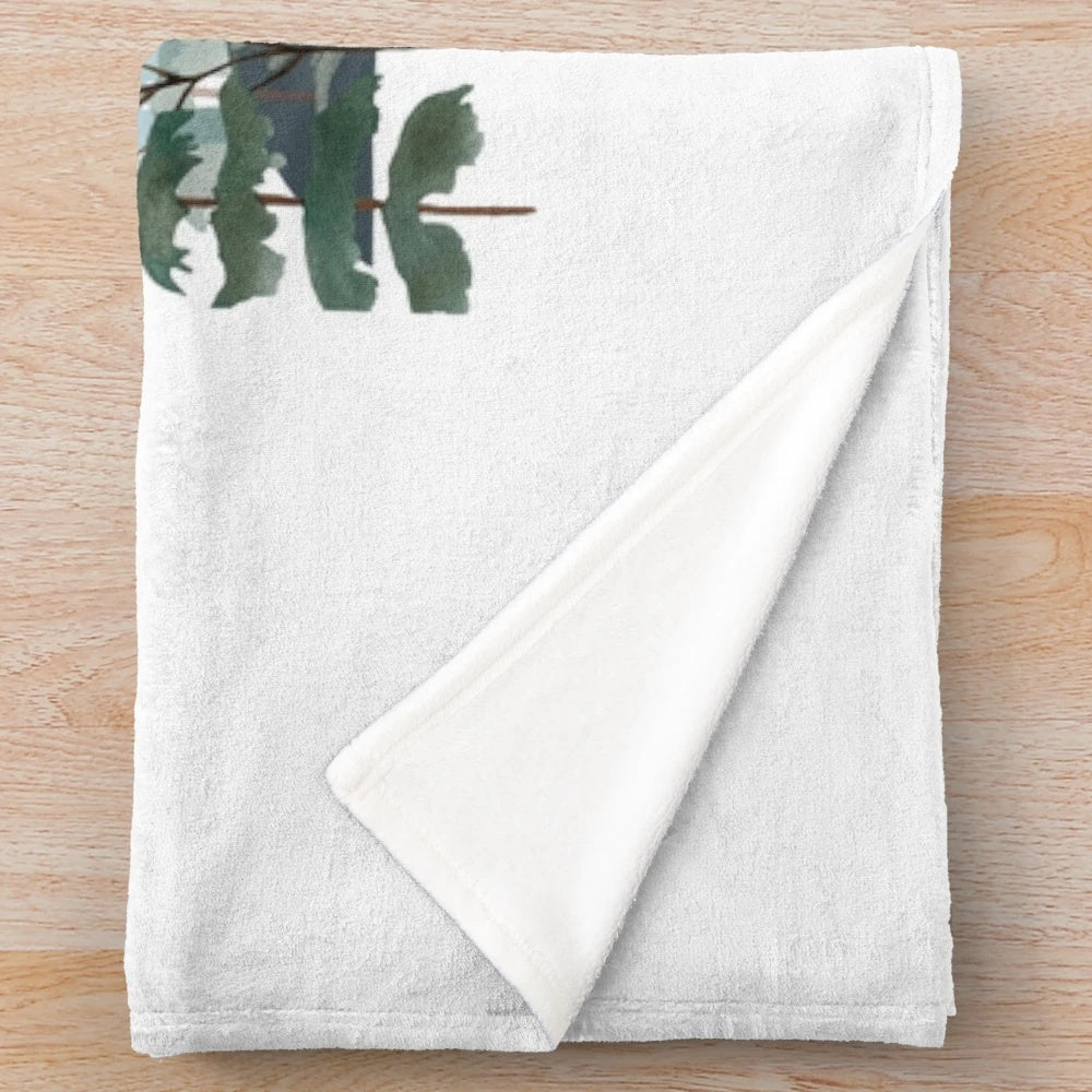 Plush blanket featuring a whimsical illustration of a forest, flora, and fauna