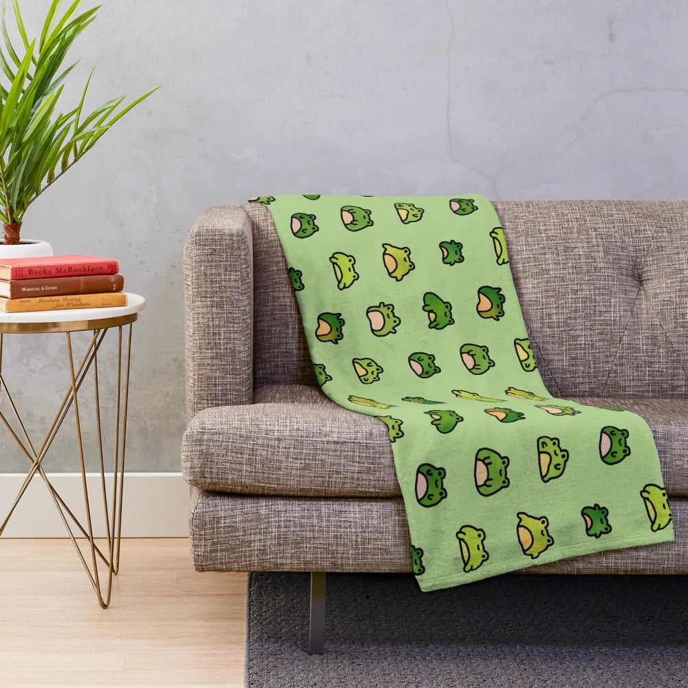 Cozy plush blanket featuring a whimsical design of doodled frogs