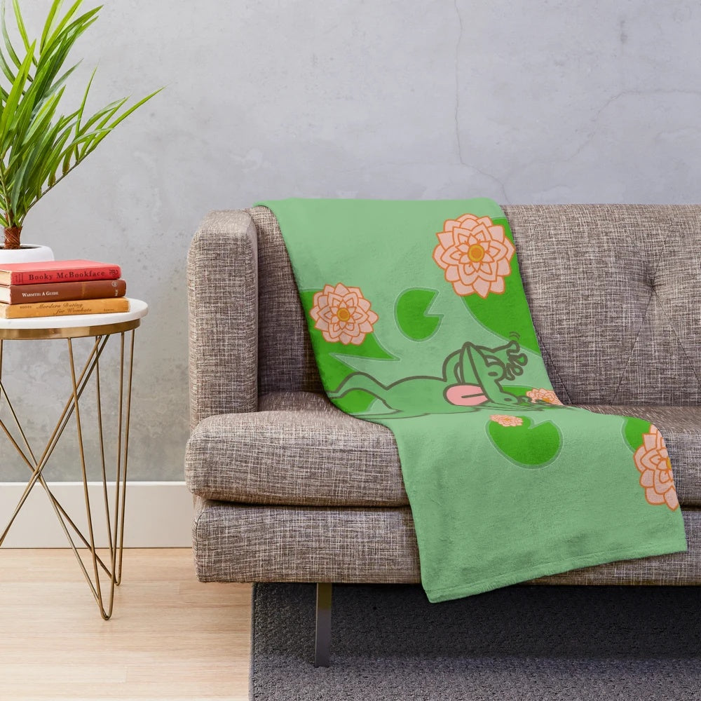 Whimsical frog plush blanket in green and pink floral design