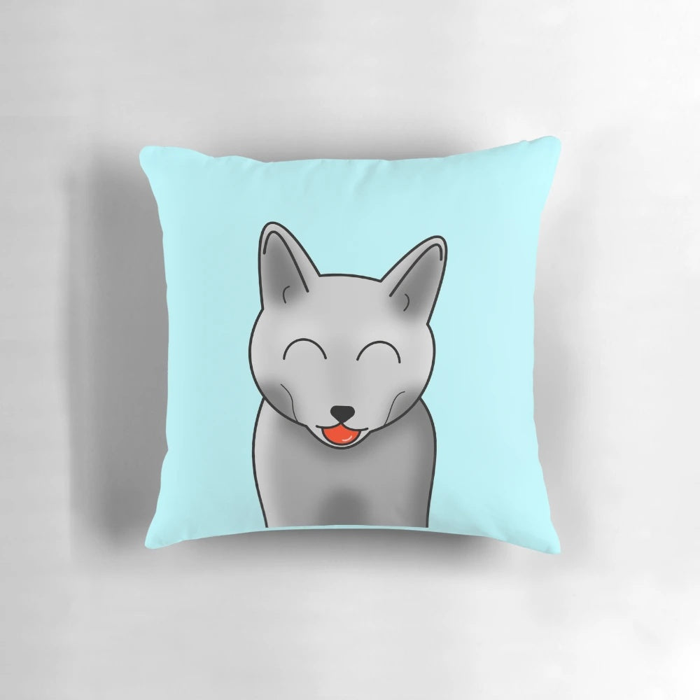 A cheeky gray cat with closed moon eyes printed on a soft, plush pillow.