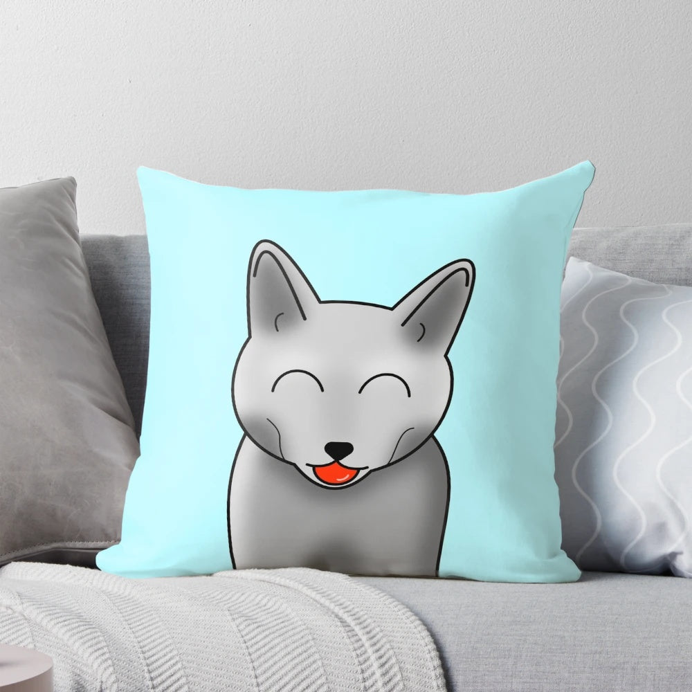 A cheeky gray cat with closed moon eyes printed on a soft, plush pillow.