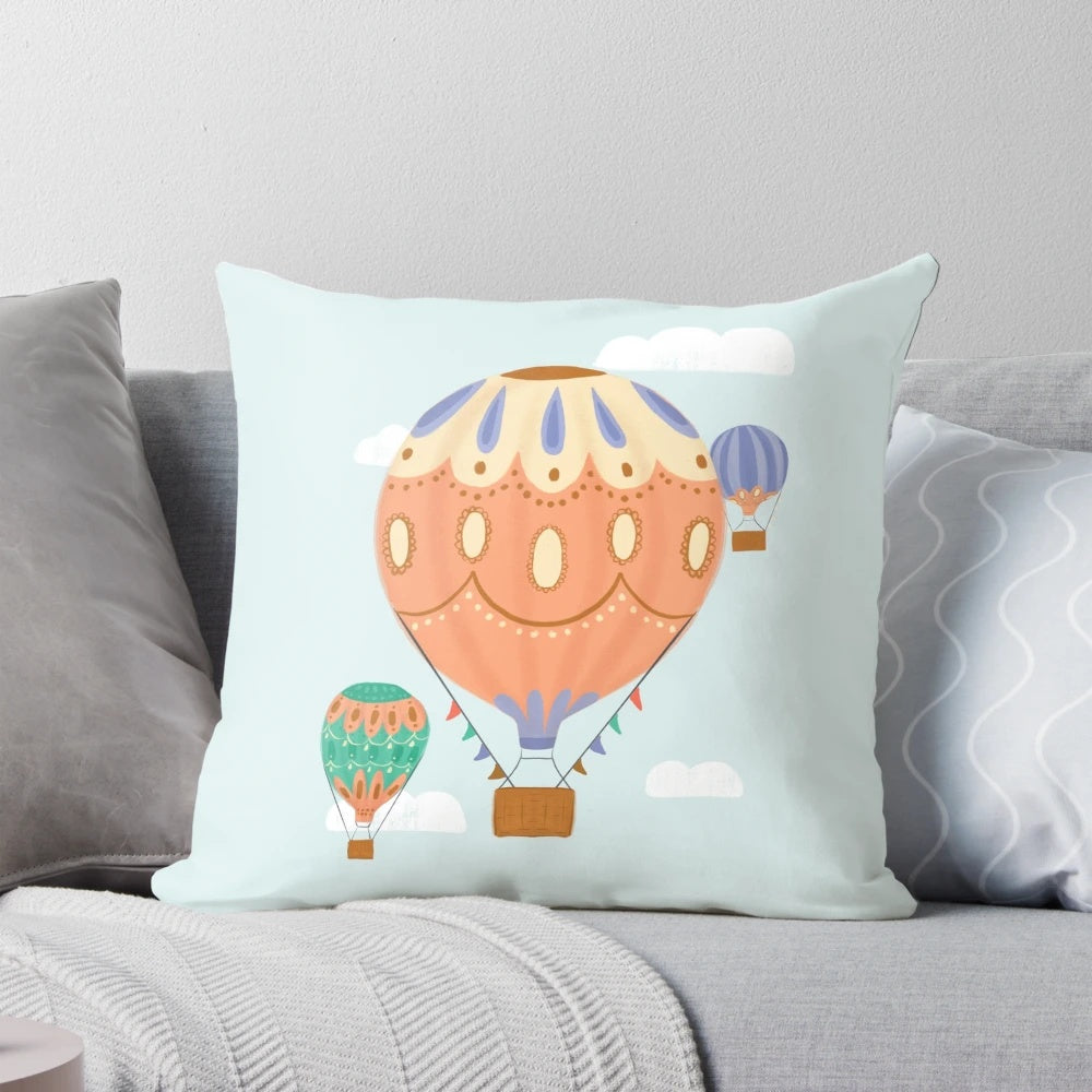 Colorful hot air balloon illustration on a plush pillow, perfect for a child's room or nursery