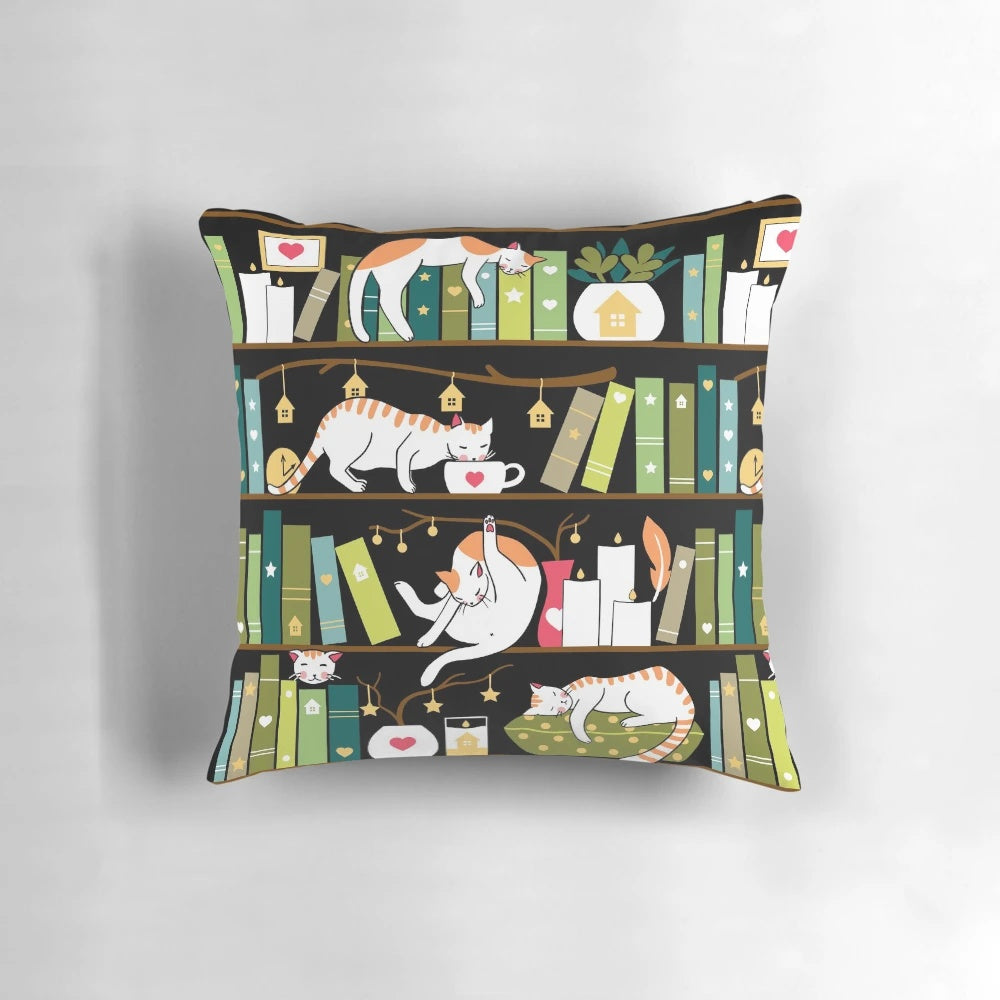 Whimsical library cats sitting on book shelves printed on a decorative throw pillow