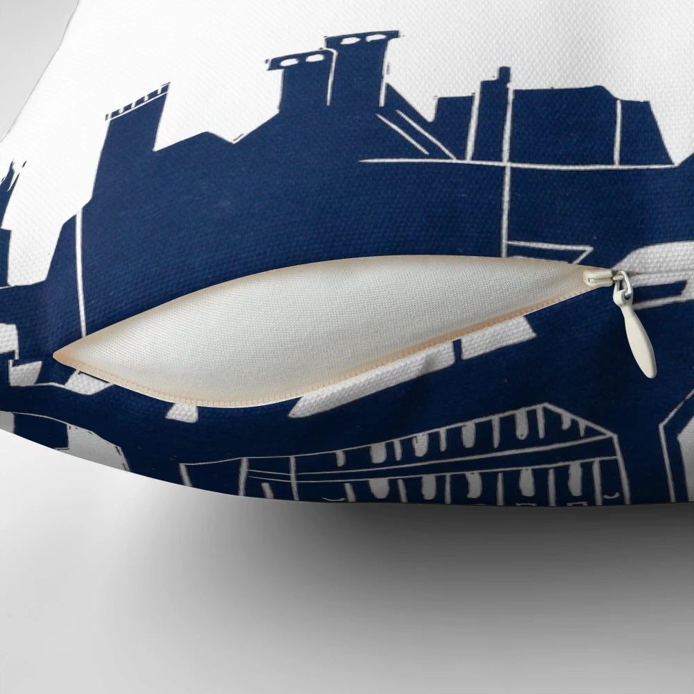A throw pillow featuring a linocut design of the London skyline with Mary Poppins silhouette.
