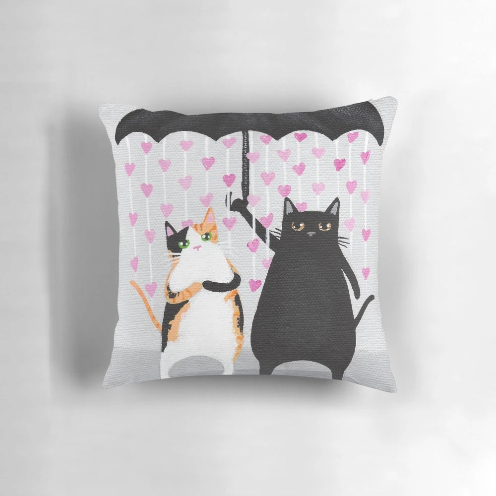 Whimsical decorative throw pillow featuring a design of love cats with raining hearts in calico and black