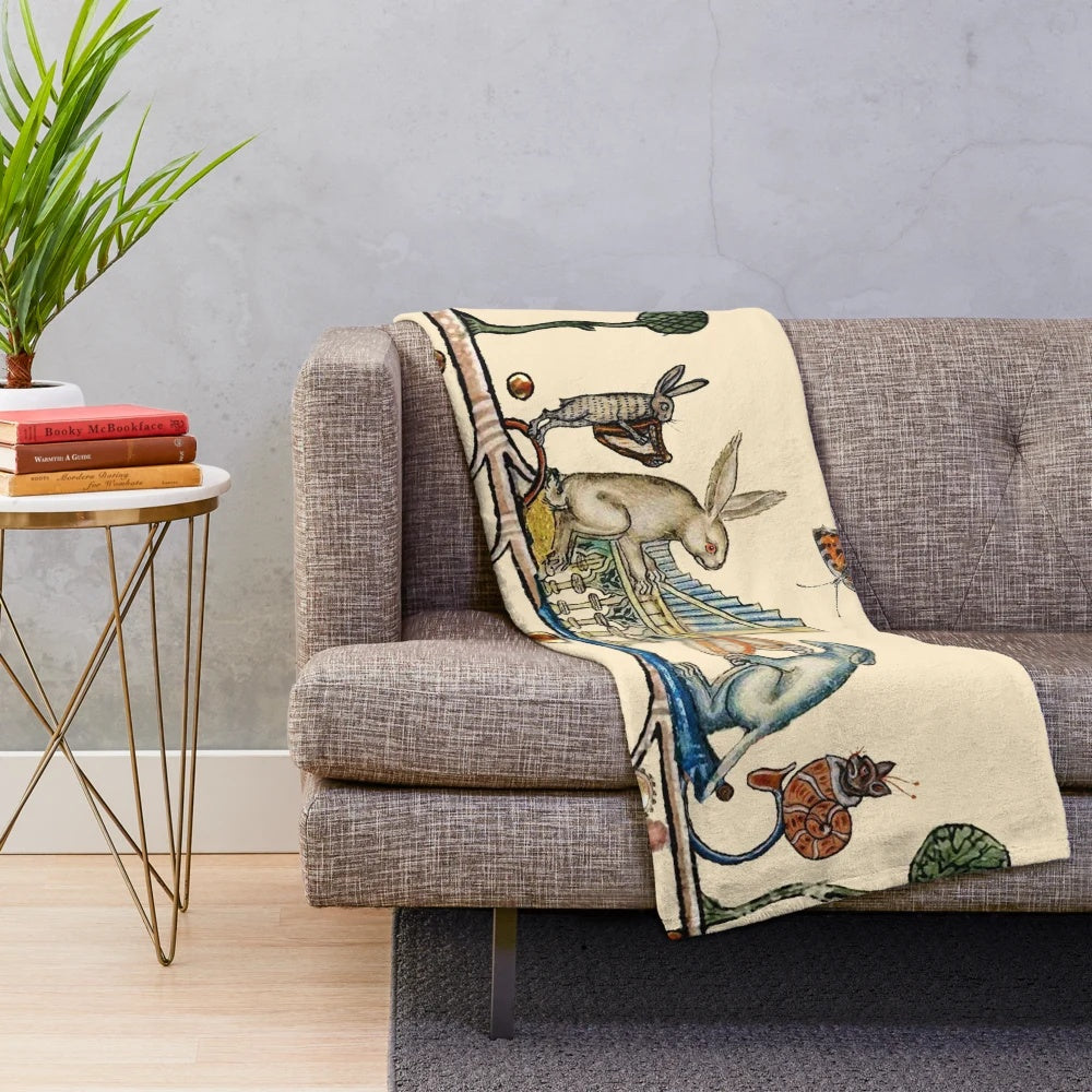 Plush blanket featuring a medieval bestiary scene with a white rabbit, dog, hare, and snail cat playing various musical instruments