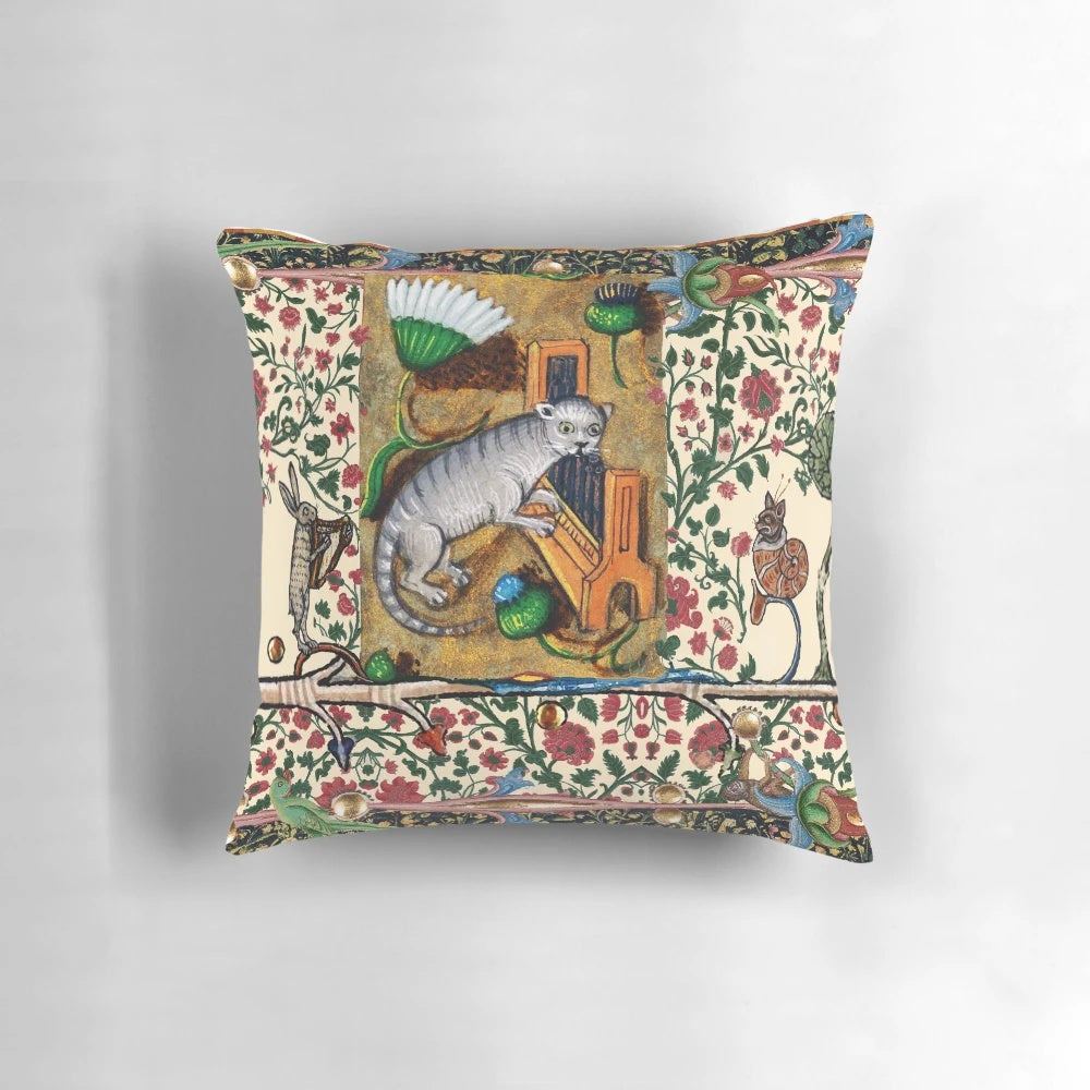 Charming medieval-inspired pillow featuring a cat playing an organ, a rabbit playing a harp, and a snail-like cat, surrounded by forest animals and thistles.