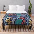 Plush blanket with multicoloured wild mushroom illustrations on a midnight blue background