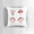 Four adorable mushroom characters on a soft, decorative pillow for a fairy tale-inspired room.