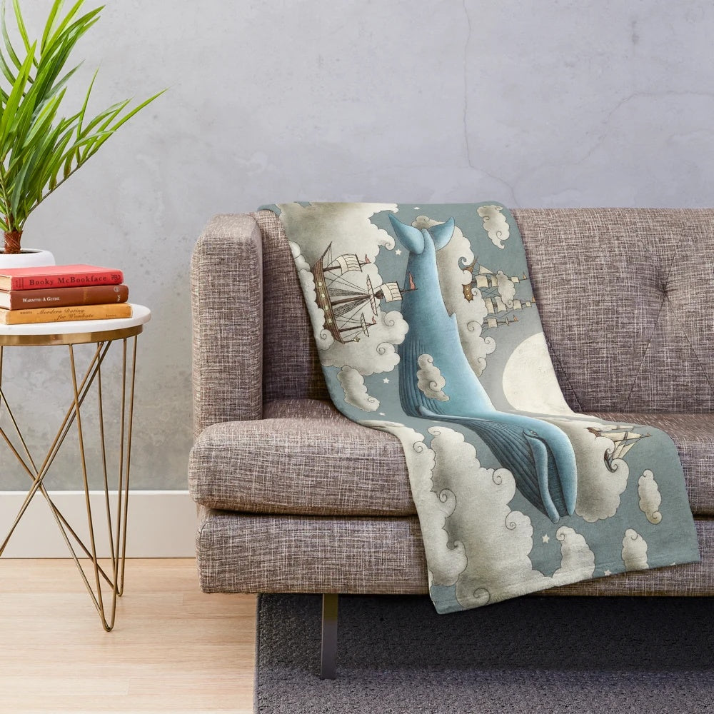 Whimsical ocean plush blanket with surreal skies and nature elements