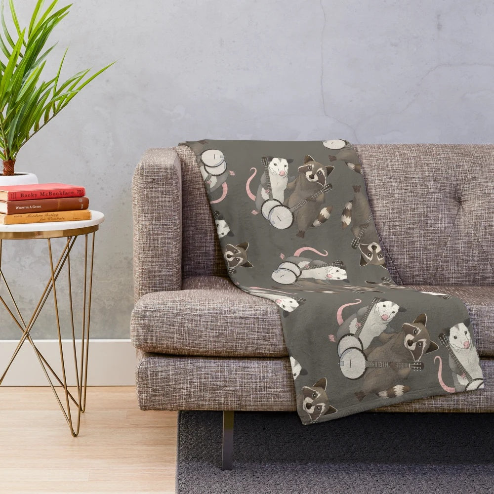 Opossum and raccoon playing banjos on a plush blanket