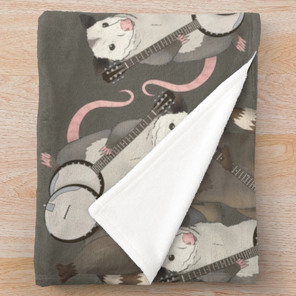 Opossum and raccoon playing banjos on a plush blanket
