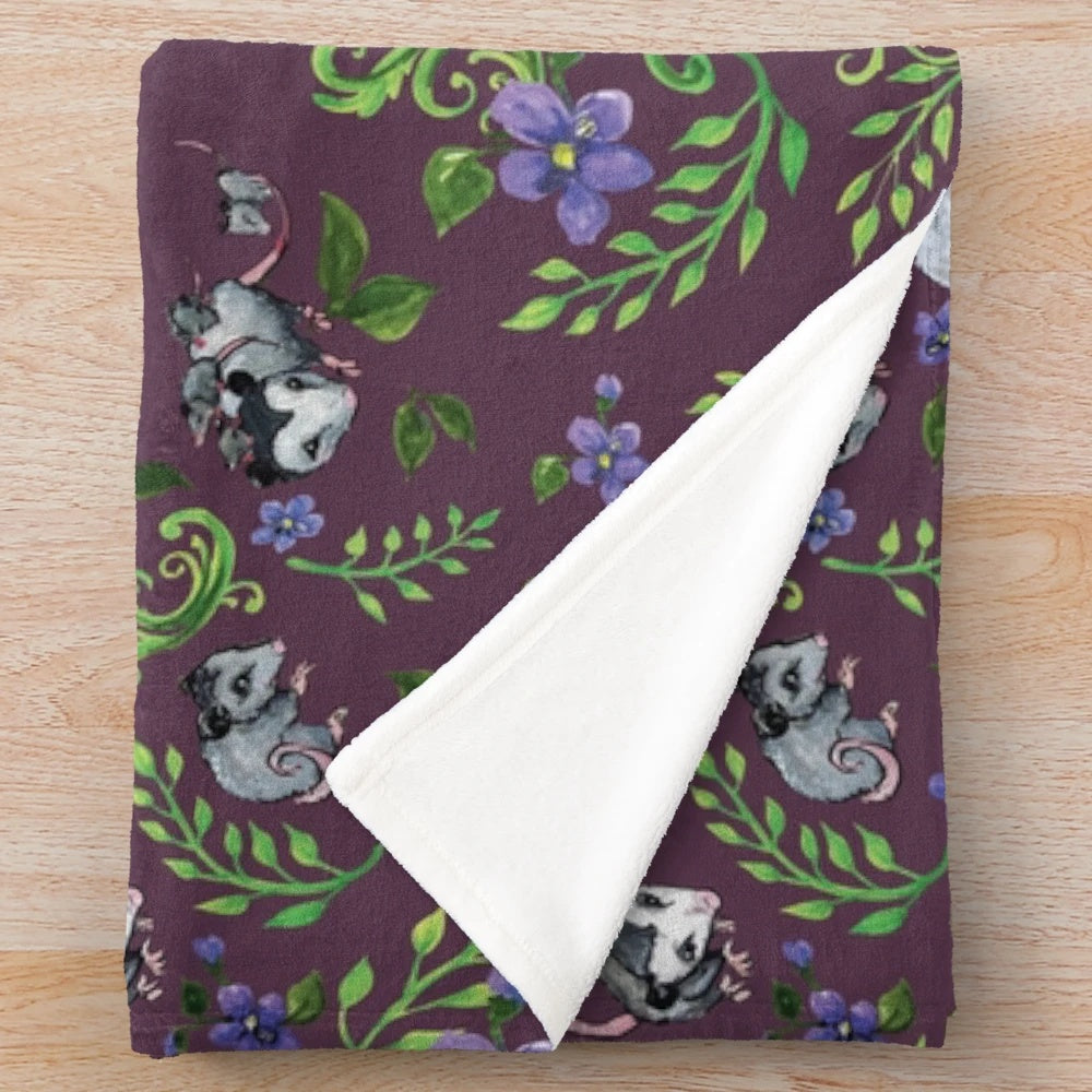 Opossum, fern, and violet print plush blanket