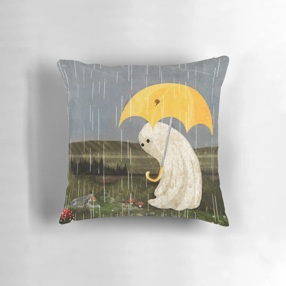 A plush, whimsical pillow featuring a design with rain, nature elements, and a ghost, perfect for cozy, enchanted home decor.