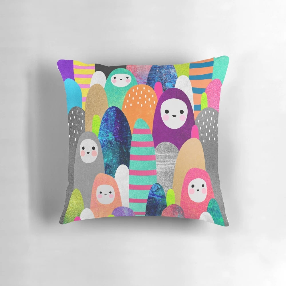Colorful, nature-inspired pebble spirits pillow with a whimsical design