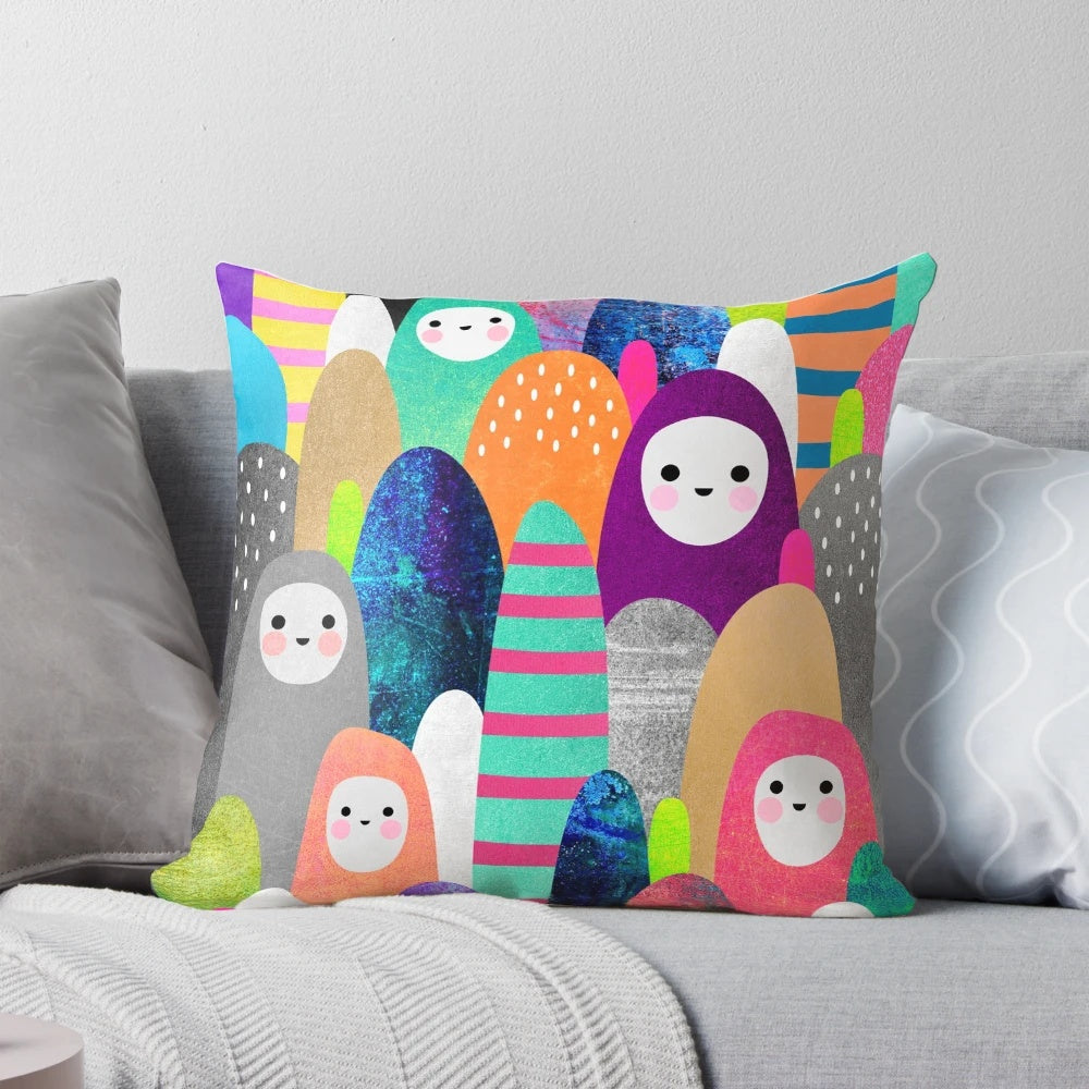 Colorful, nature-inspired pebble spirits pillow with a whimsical design
