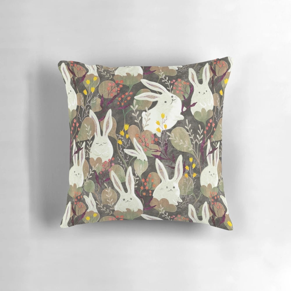 Whimsical decorative pillow with a rabbit and floral pattern design