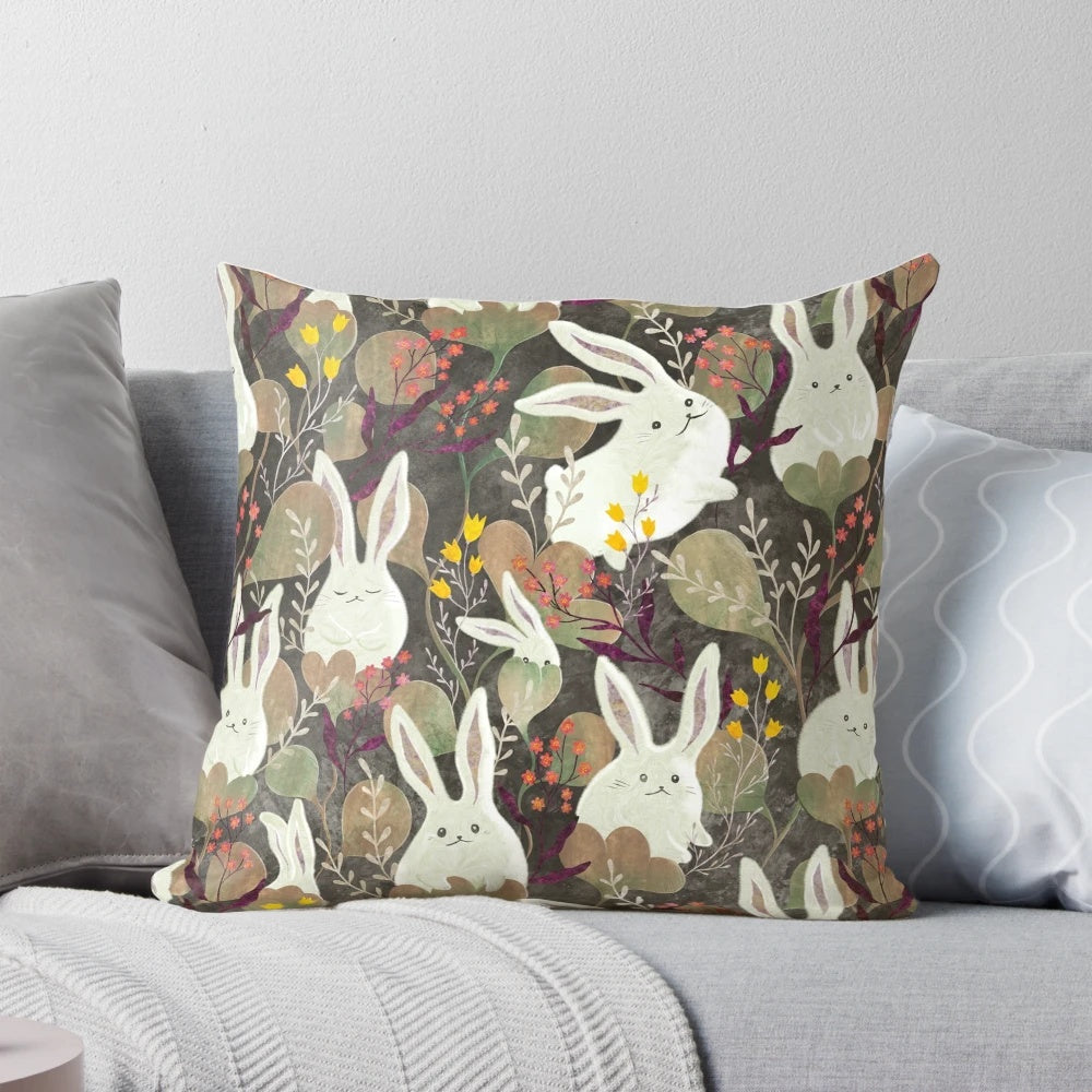 Whimsical decorative pillow with a rabbit and floral pattern design