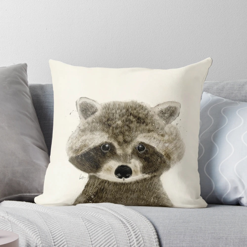 Whimsical watercolor illustration of a cute raccoon on a plush pillow, perfect for nature inspired home decor or a child's nursery.