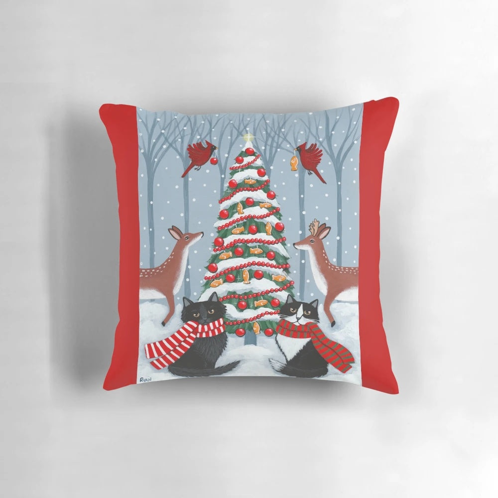Tuxedo cat and black cat sitting on a snowy Christmas tree in a whimsical woodland scene