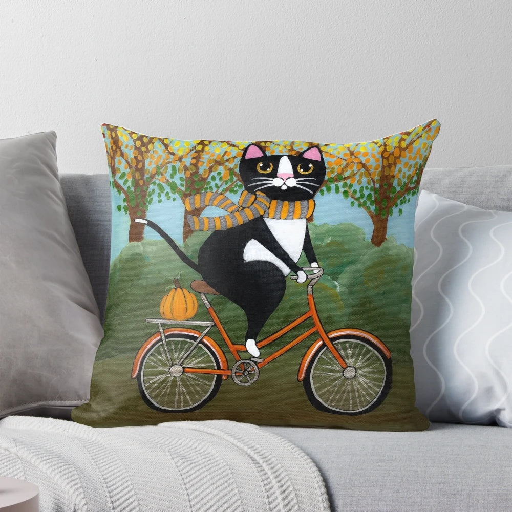 A tuxedo cat riding a bicycle surrounded by autumn leaves and pumpkins