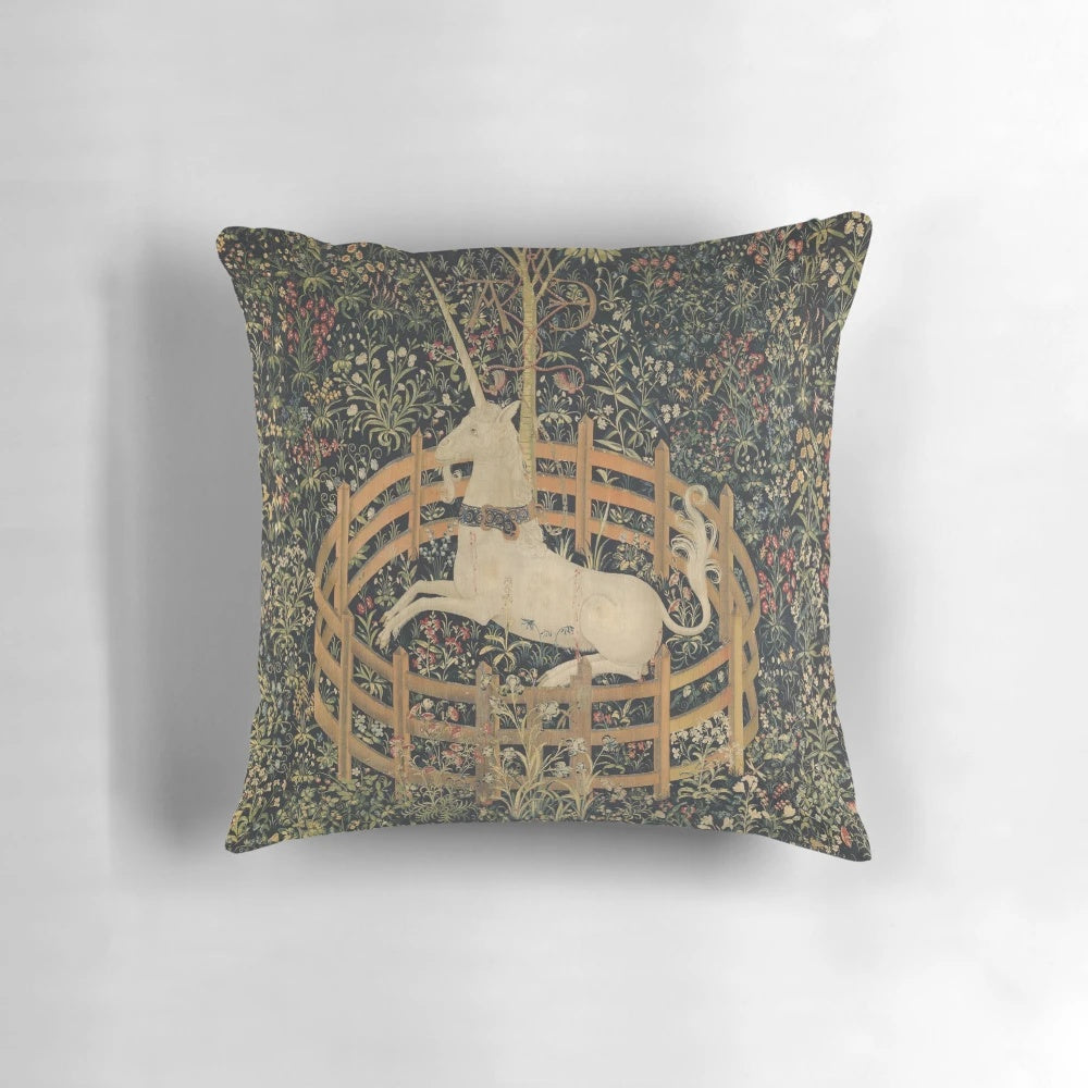A decorative throw pillow featuring a majestic unicorn in a captivating medieval-style setting, surrounded by lush botanical elements.
