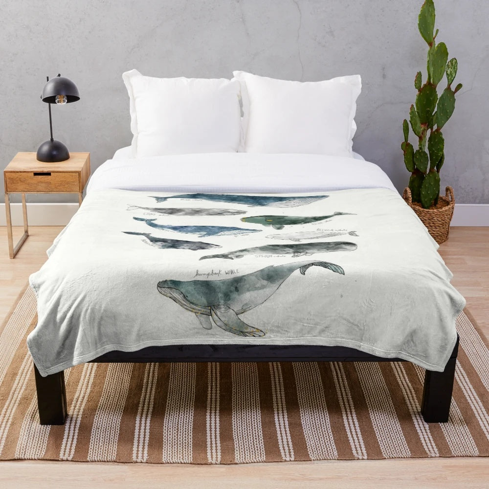 Whimsical watercolor whales design on a soft and cozy plush blanket