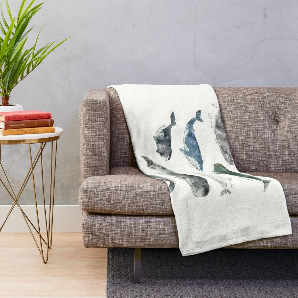 Whimsical watercolor whales design on a soft and cozy plush blanket