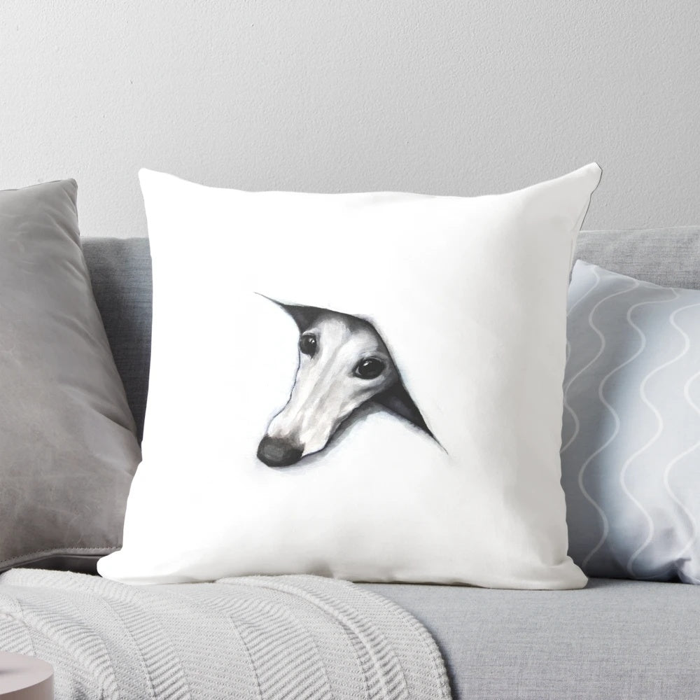 Whimsical whippet peeking out from behind a plush pillow