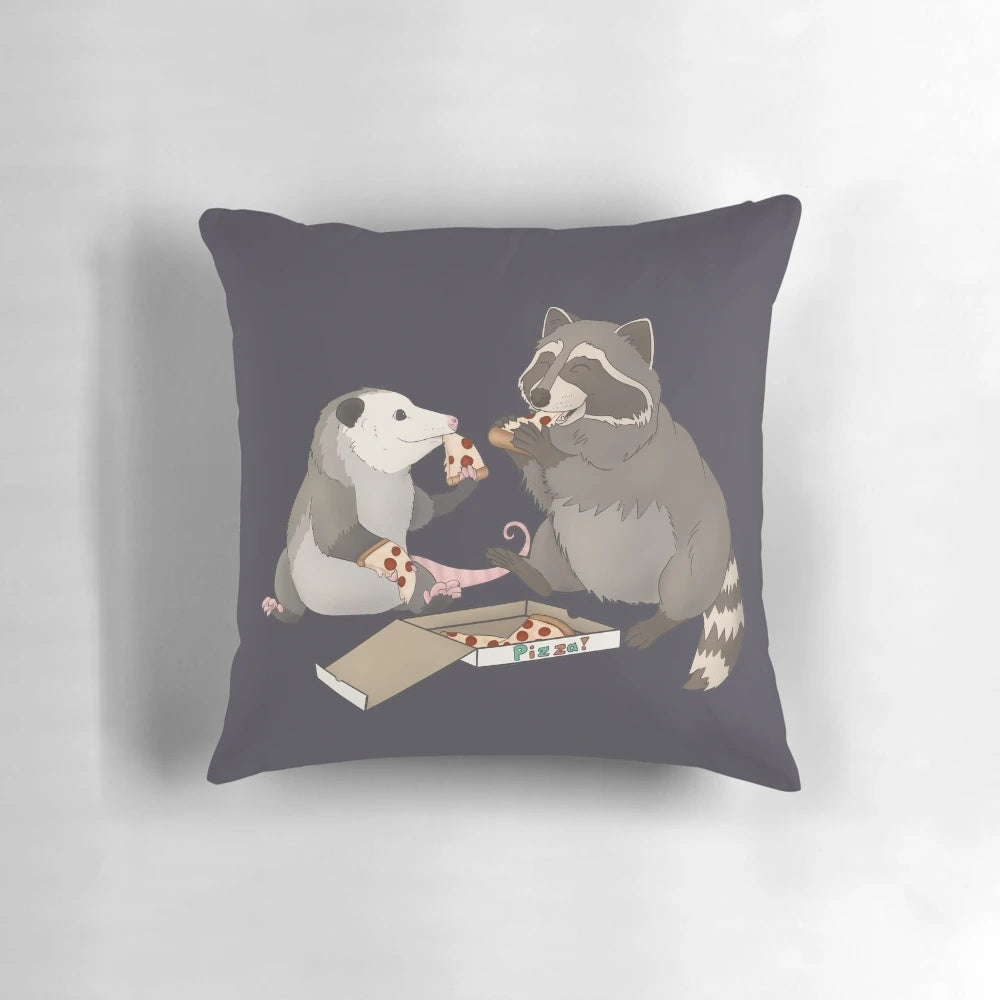 An illustration of a possum and raccoon eating a slice of pizza on a decorative pillow