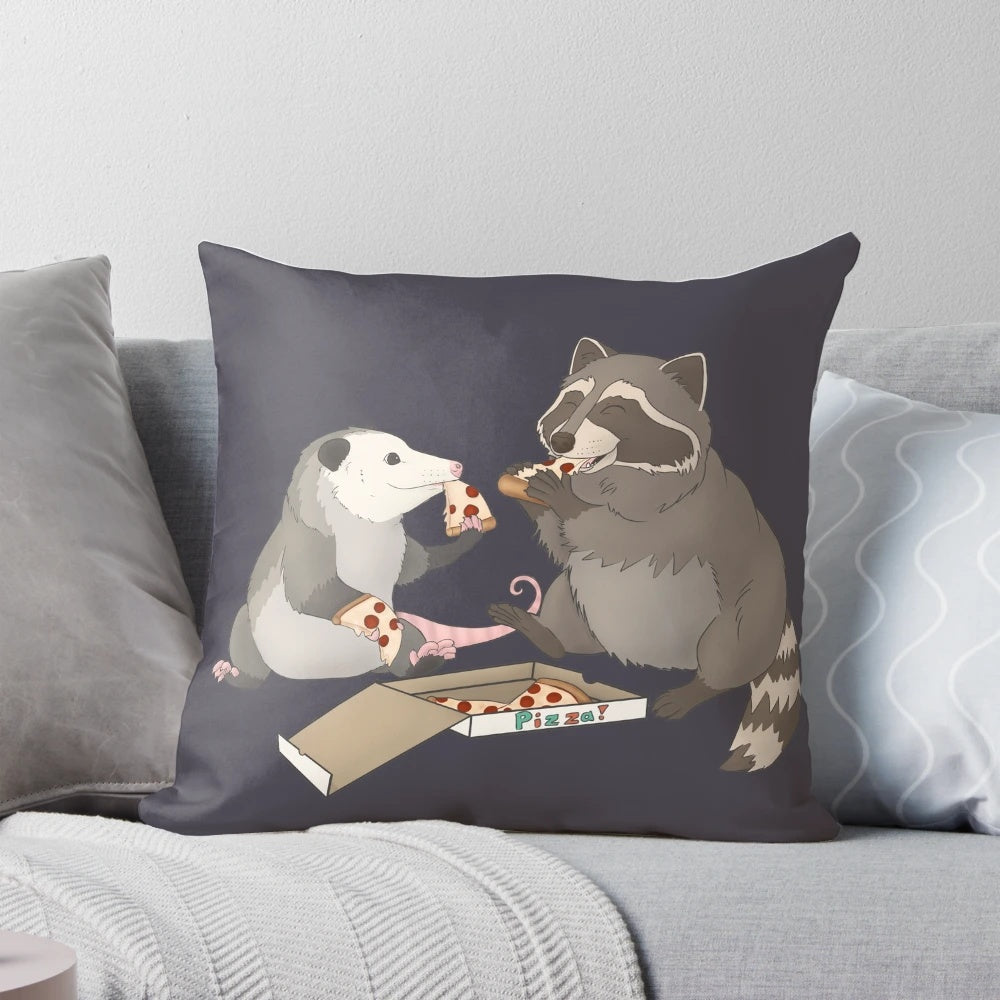 An illustration of a possum and raccoon eating a slice of pizza on a decorative pillow