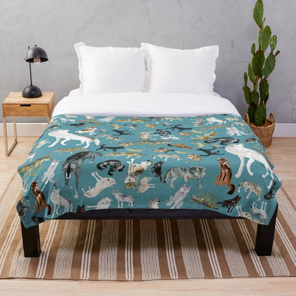 Plush blanket featuring a whimsical wolf design in shades of turquoise and gray