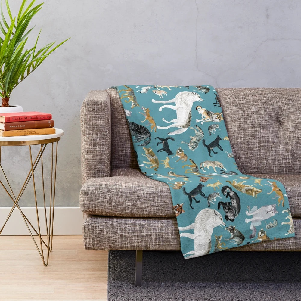 Plush blanket featuring a whimsical wolf design in shades of turquoise and gray