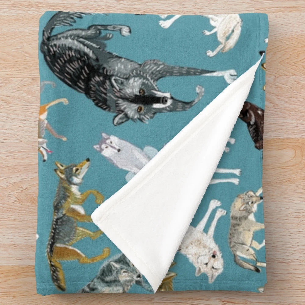 Plush blanket featuring a whimsical wolf design in shades of turquoise and gray