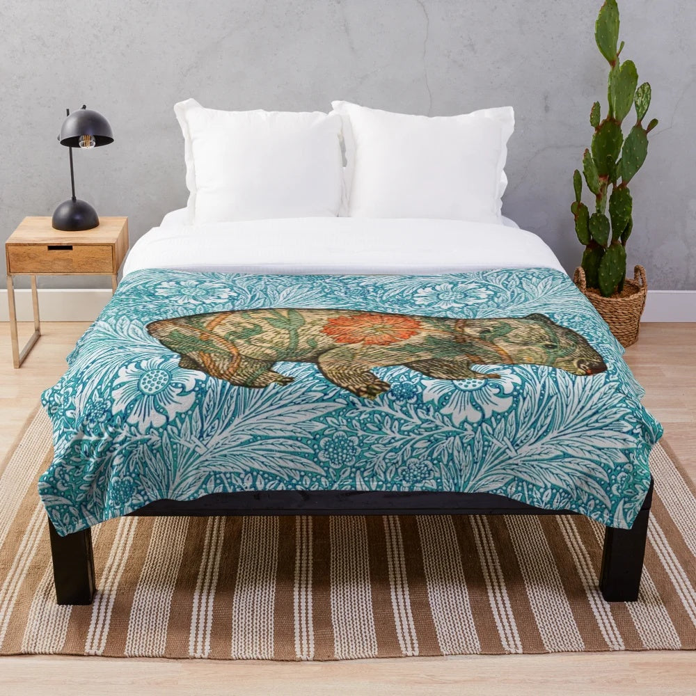 Soft plush blanket featuring a wombat design inspired by Dante Gabriel Rossetti's artwork and William Morris' blue marigold floral pattern