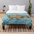 Soft plush blanket featuring a wombat design inspired by Dante Gabriel Rossetti's artwork and William Morris' blue marigold floral pattern